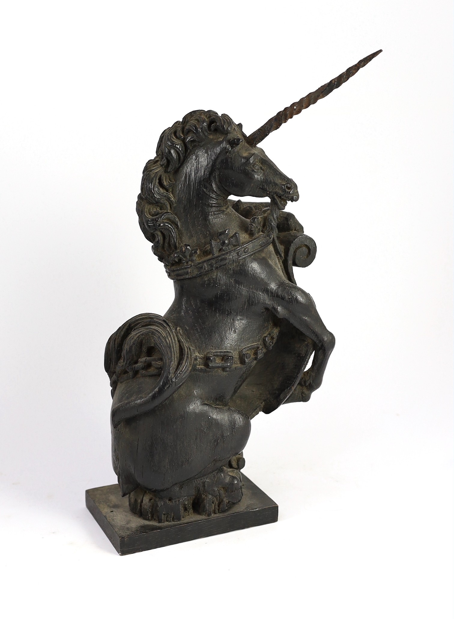 A pair of 18th century carved and ebonised oak heraldic beasts, lion and unicorn, 42cm high